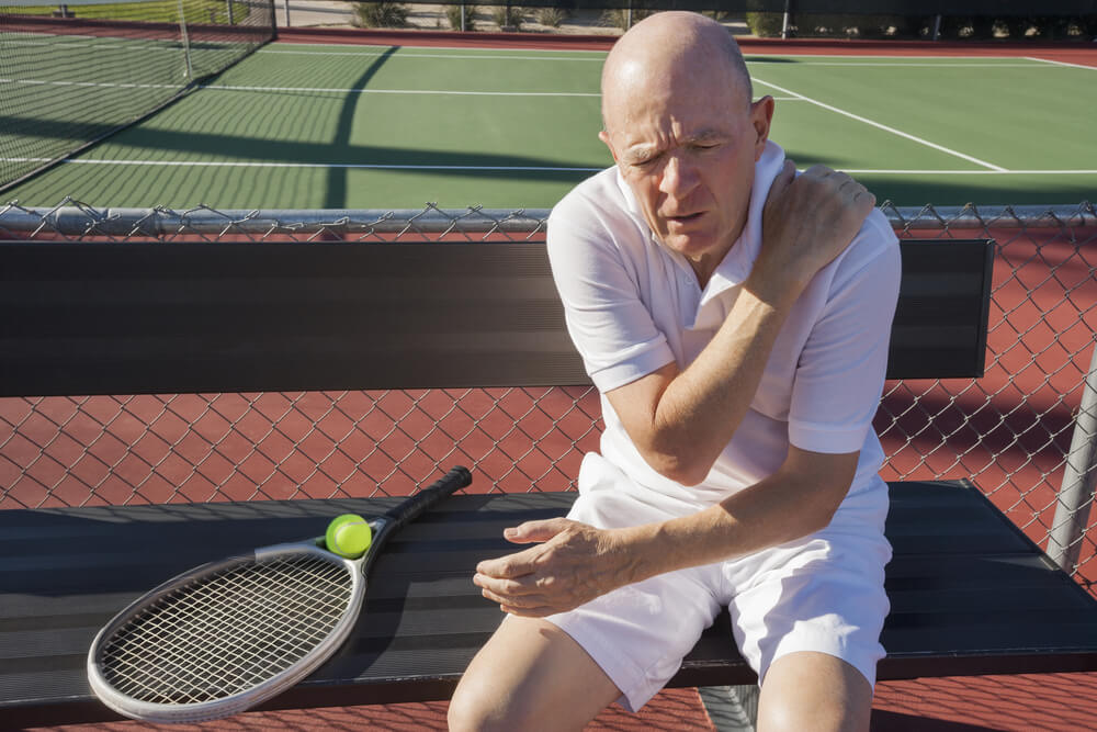 When should I seek treatment if the top of my shoulder hurts?
