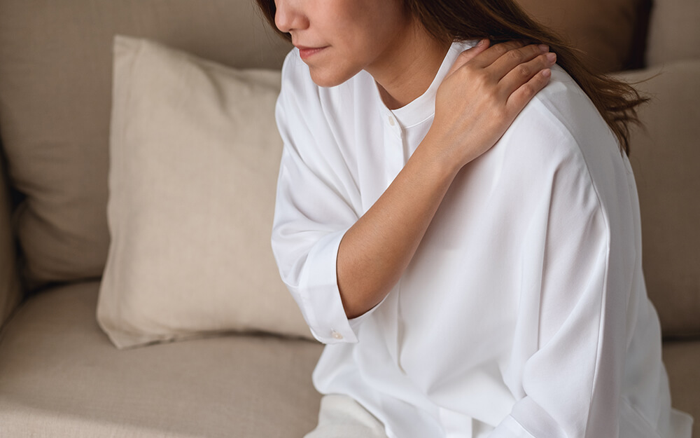 Shoulder pain and 4 other surprising TMJ symptoms closeup image of a sick woman suffering from backa 2022 12 16 05 36 59 utc Shoulder pain and 4 other surprising TMJ symptoms