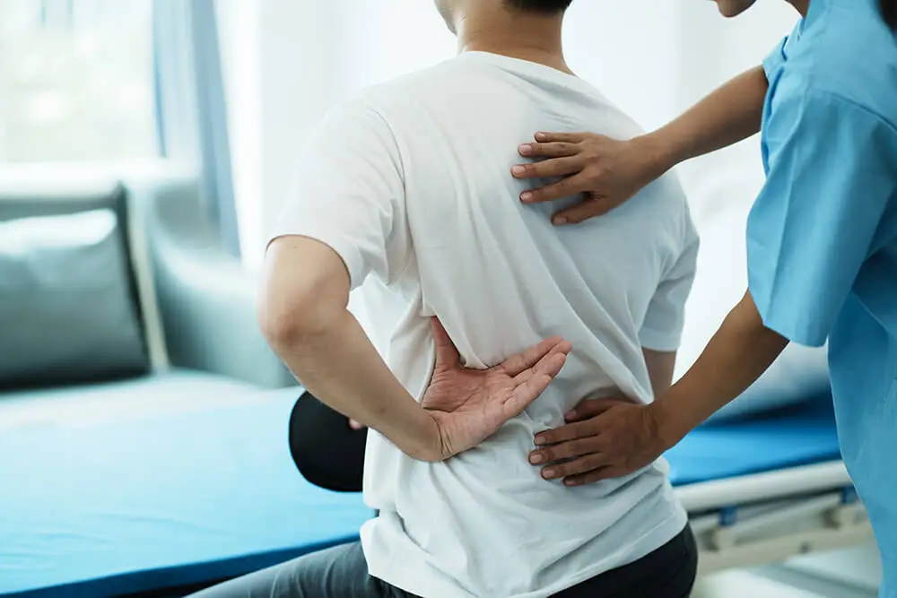 Shoulder blade pain: Causes, symptoms and treatments doctor consulting with patient back problems physi 2023 05 22 23 40 07 utc Shoulder blade pain: Causes, symptoms and treatments